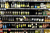 Rows of olive oil bottles displayed on supermarket shelves in Rome.