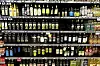 Rows of olive oil bottles displayed on supermarket shelves in Rome.