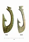 Stone Age fish hooks against a white background