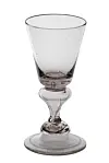 Clear vintage-style stemmed glass on a white background.