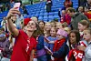 Football player Vilde Bøe Risa takes a selfie with a group of girls in the stadium after a World Cup qualifying match.