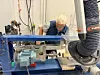 Senior technician working at a milling machine on oak samples in a workshop at SINTEF.