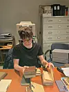 Dirk Johannsen sits in an office looking through books