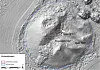 Shaded relief map of a crater with blue outline, labelled points and a small inset map.