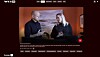 A screenshot from a streaming service showing a video of two people in a warmly lit room.
