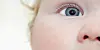 Close up of a small child with a blue eye