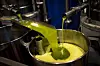 Olive oil pours into a stainless steel tank at La Betica Aceitera mill in Spain.
