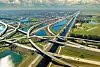 Aerial view of a multi-level motorway interchange with bridges, ramps and waterways.