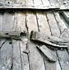 Close-up of aged wooden ship planks with cracks, splits and layered timbers from the Sørenga 2 ship.