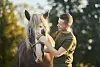 Man brushing a horse