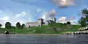 Illustration of Avaldsnes Church and the attached royal estate. The complex is shown from the sea, as it would have appeared to ships sailing past.