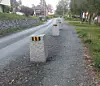 Concrete blocks marking a temporary bike lane on a residential street in Trondheim.