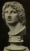 A marble bust of a classical sculpture on a pedestal against a dark background.