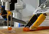 A robot cutting salmon sashimi