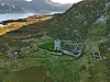 Stone ruins and a newly found wall on Selja, set on a hillside above the coast.