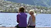 Two kids sitting on a pier