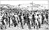 Large group of people fighting in an open area with mountains in the background.