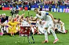 Norway footballers celebrate on the pitch, with one player performing a rowing gesture in front of teammates.