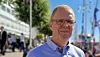 Bjørn Arne Rukke wearing glasses and a blue shirt outdoors in an urban setting.