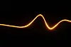Glowing orange wave tracing a smooth curve across a black background.