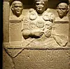 Carved Roman tombstone with portrait figures and a Latin inscription honouring Marcus Caelius.