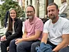 Three people photographed outdoors.