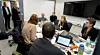 A group works around a conference table with laptops during a Norwegian Cyber Range exercise.
