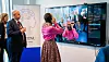 A woman in pink tests a security system displayed on a monitor at NTNU Gjøvik.