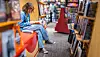 Teenage girl reading in a bookstore.