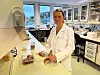 Nofima researcher Solveig Langsrud examines chicken samples on a laboratory workbench.
