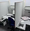 Sensory-testing booths with chicken fillet samples, computers, chairs and response forms.
