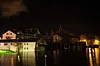Water levels high up against building walls at night.