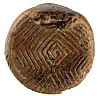 Rounded brown artefact with an intricate incised geometric pattern.