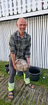 Man holding a large stone