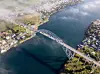 Aerial view of the Karmsund Bridge crossing blue water between coastal settlements.