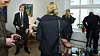 Adults gather in a bright apartment as family support helps young people move towards home ownership.